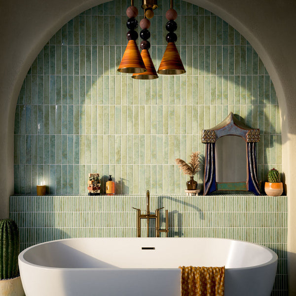 Shower interior with Pottery Decor Prussian wall tiles 12.5 × 25cm, laid vertically to enhance height. Deep blue glazed tones with subtle variation add depth, paired with a built-in niche, tiled bench, and brushed brass fittings for a refined finish.