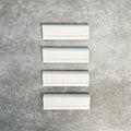 Pimlico White dado trim tiles measuring 5 × 15cm, finished with a crackle glaze and soft white tone, designed to add a decorative feature line and classic detail to ceramic wall tile layouts.