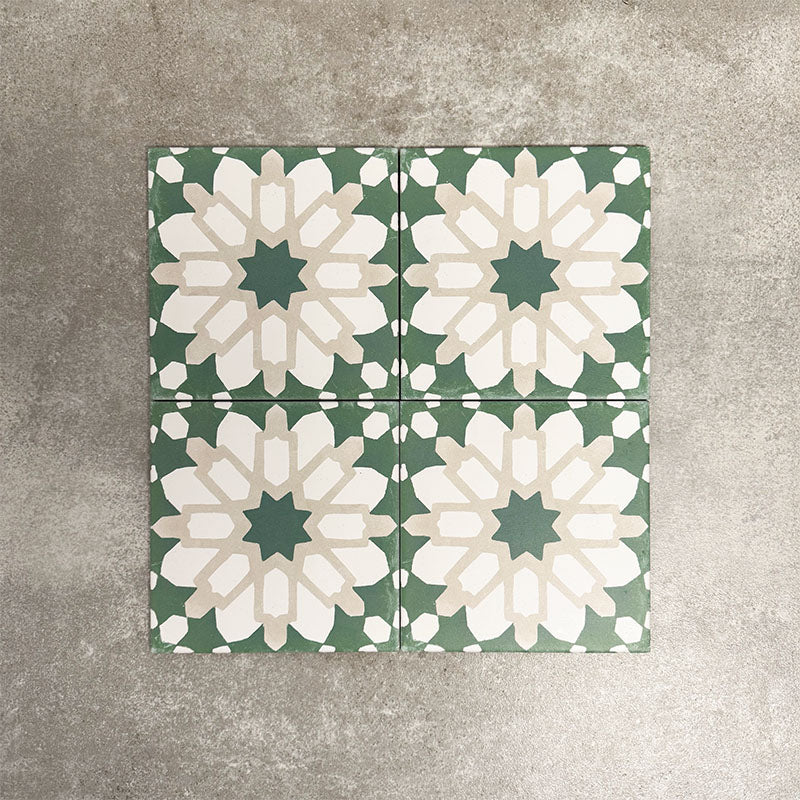 Souk Green D 20×20cm Moroccan-style porcelain tiles arranged in a green, white and beige geometric pattern.