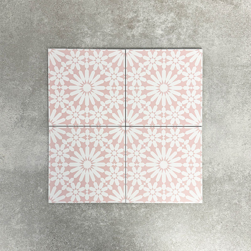 Fez Rose Pink Moroccan-style porcelain tile in a 20 × 20cm square format. The design features a soft blush pink background with a crisp white geometric starburst pattern inspired by traditional Moroccan motifs. Delicate yet detailed, the symmetrical pattern creates a light, elegant look that feels both decorative and refined—ideal for adding subtle colour and pattern to floors or walls without overwhelming a space.