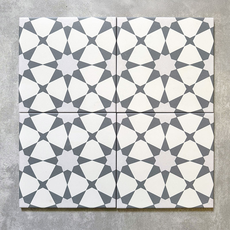 Agadir Silver Moroccan-style 20x20cm porcelain tiles shown as a four-tile layout, featuring a soft grey and white geometric star pattern with a clean, modern Moroccan look.