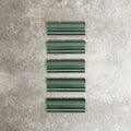 Pimlico Golders Green dado trim tiles measuring 5 × 15cm, finished with a crackle glaze and rich green tone, designed to add a decorative feature line and classic detailing to ceramic wall tile installations.