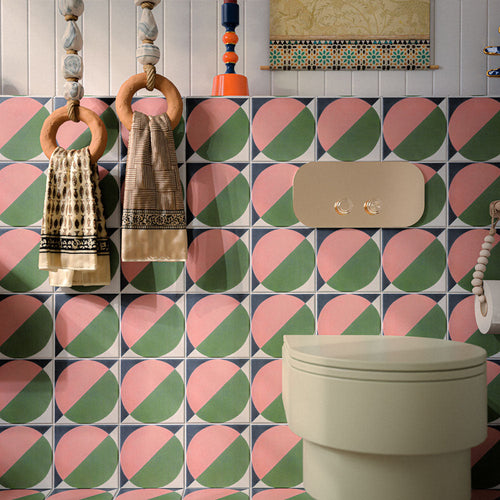 Bathroom featuring Abstract Moon 20x20cm patterned tiles in soft pink and green tones, styled with eclectic décor, statement accessories, and contemporary sanitaryware for a bold playful interior design.