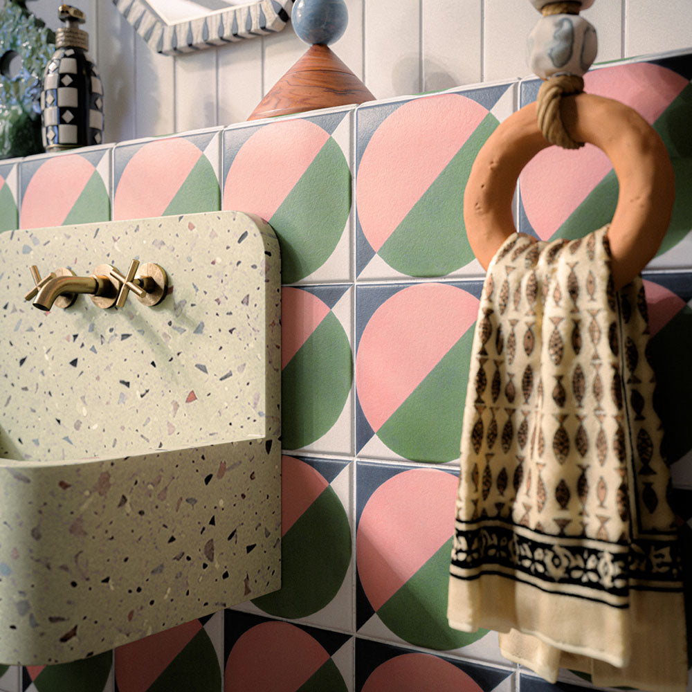 Bathroom featuring Abstract Moon 20x20cm patterned tiles in soft pink and green tones, styled with eclectic décor, statement accessories, and contemporary sanitaryware for a bold playful interior design.