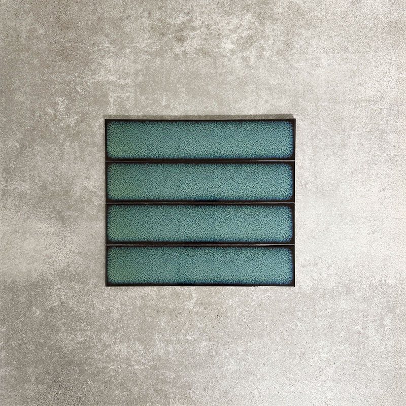 Alchemy Hunter Green 6.5×30cm ceramic wall tiles with a glossy green finish, shown as a group of rectangular tiles.