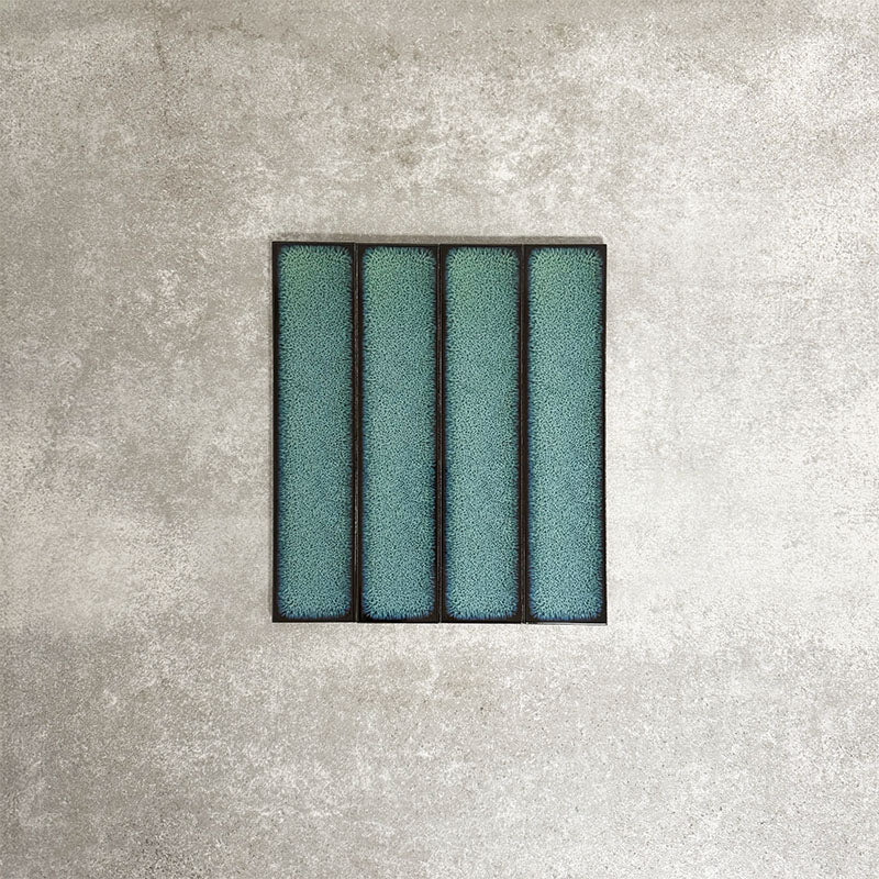 Alchemy Hunter Green 6.5×30cm ceramic wall tiles with a glossy green finish, shown as a group of rectangular tiles.