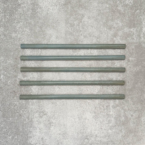 Allegra Celadon Green Gloss pencil bullnose border ceramic tiles in a 1.2 × 30cm format, shown as a set to highlight the soft green tones, glossy finish, smooth rounded edges and subtle handmade-style variation for decorative borders and trims.