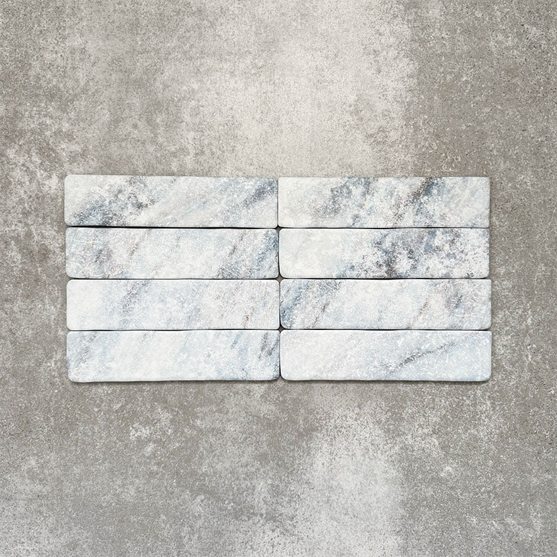 Product image of Amalfi Brick Azul Vintage Marble wall and floor tiles in a 5.4cm x 22cm format, showcasing soft blue and white marble effect detailing with subtle veining and tonal variation.