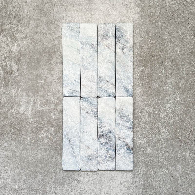 Product image of Amalfi Brick Azul Vintage Marble wall and floor tiles in a 5.4cm x 22cm format, showcasing soft blue and white marble effect detailing with subtle veining and tonal variation.