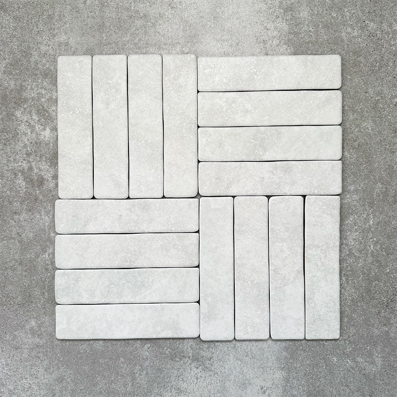 Product image of Amalfi Brick Carrara Vintage Marble wall and floor tiles in a 5.4cm x 22cm format, arranged in a basketweave pattern, showcasing a soft white marble effect surface with subtle tonal variation.