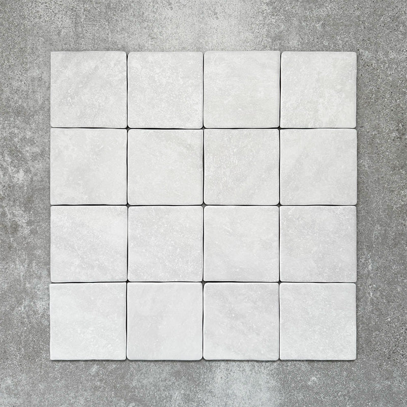 Product image of Amalfi Square Carrara Vintage Marble wall and floor tiles in an 11cm x 11cm format, featuring a soft white marble effect surface with subtle tonal variation and gently rounded edges.