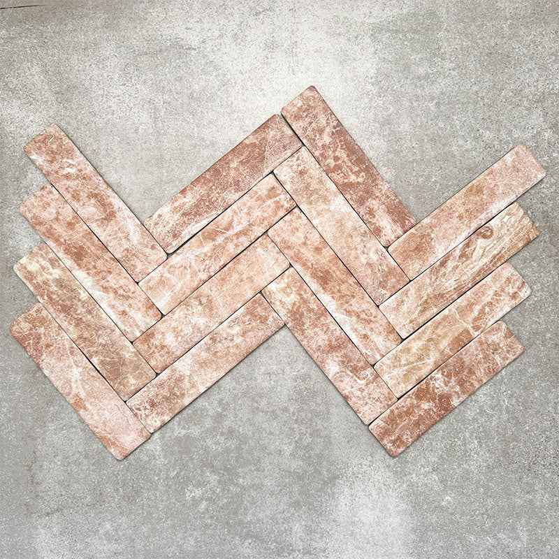 Product image of Amalfi Brick Rouge Vintage Marble wall and floor tiles in a 5.4cm x 22cm format, arranged in a herringbone pattern, showcasing warm blush pink marble effect detailing and natural tonal variation.