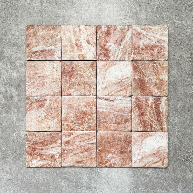Product image of Amalfi Square Rouge Vintage Marble wall and floor tiles in an 11cm x 11cm format, featuring warm blush pink marble effect detailing, natural tonal variation and softly rounded edges.