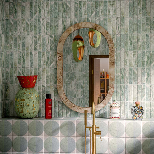 Bathroom featuring Amalfi Brick Salvia Vintage Marble 5.4x22cm wall and floor tiles, styled with a freestanding stone bath, green patterned floor tiles, brushed brass fixtures and botanical-inspired contemporary décor.