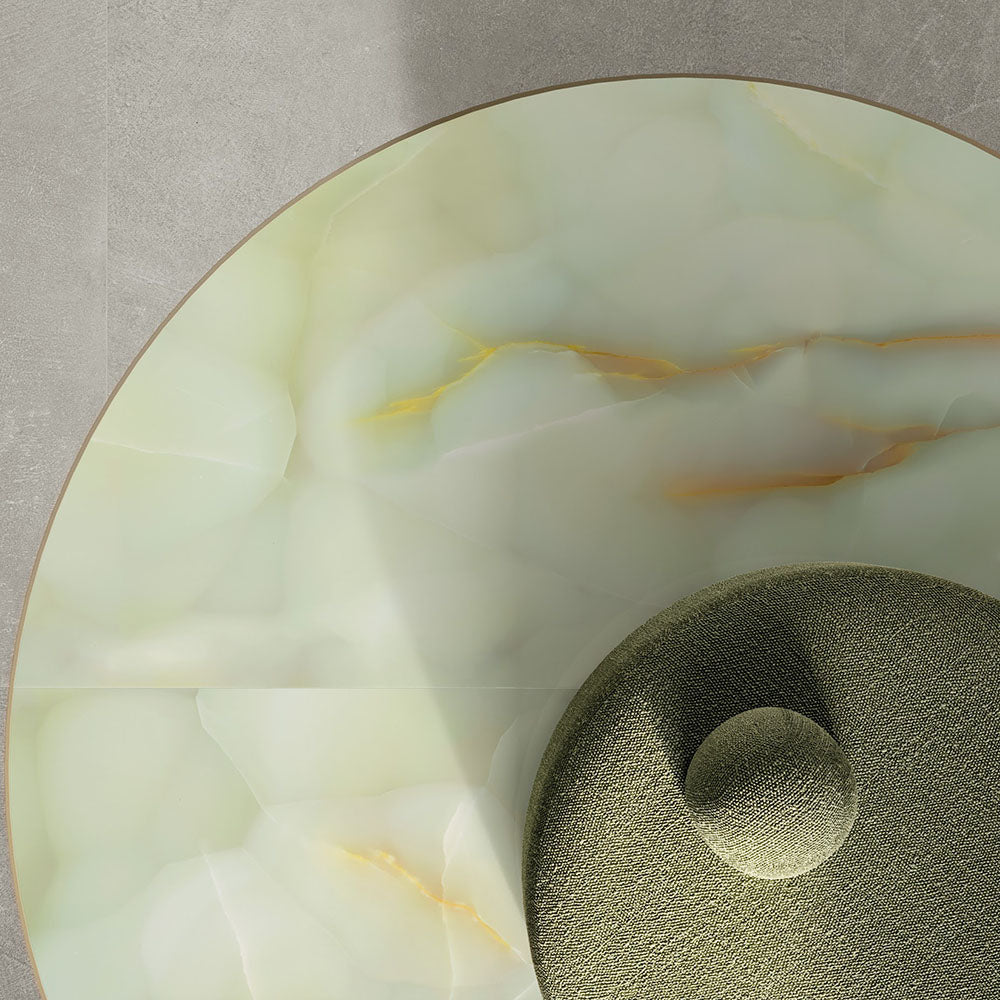 Close-up interior detail featuring Anastasia Jade Green Onyx Matt 60 × 120cm stone effect floor tiles, with soft green tones and delicate gold veining, styled with a curved upholstered chair and neutral wall backdrop.