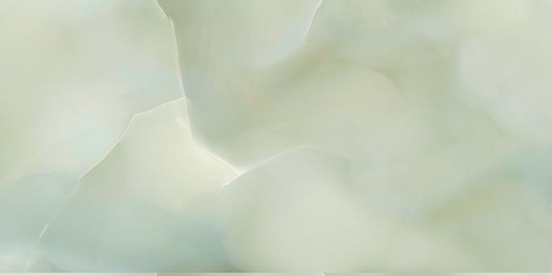 Close-up of Anastasia Jade Green Onyx Matt 60 × 120cm stone effect tile, featuring soft green tones with flowing gold and amber veining, creating a layered, organic pattern with a smooth matt finish.
