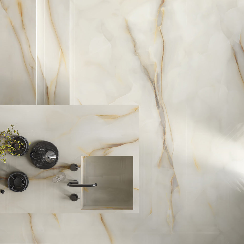 Flat lay bathroom vanity featuring Anastasia Pearl Onyx Matt 60 × 120cm stone effect tiles, with soft cream tones and delicate gold veining, paired with black fittings, integrated basin, and minimal, modern styling.