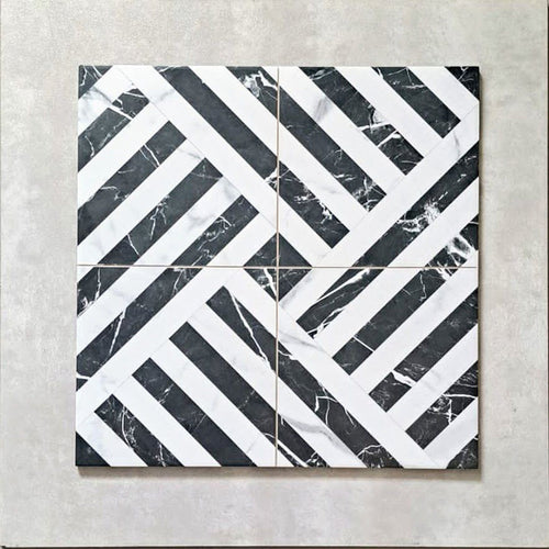 Flat lay of Art Deco Black & White marble effect patterned porcelain tiles 44 × 44cm, arranged to highlight the repeating geometric layout. The contrast between deep black marble effect segments and crisp white lines creates a bold, interlocking pattern with strong visual structure and movement.