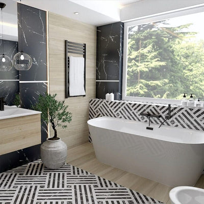 Bathroom interior featuring Art Deco Black & White marble effect patterned porcelain tiles 44 × 44cm, used across the floor and bath panel to create a bold, continuous geometric layout. The contrasting black and white tones introduce strong structure and rhythm, balanced with wood-effect wall panels, a freestanding bath, and matte black fittings for a clean, modern finish.