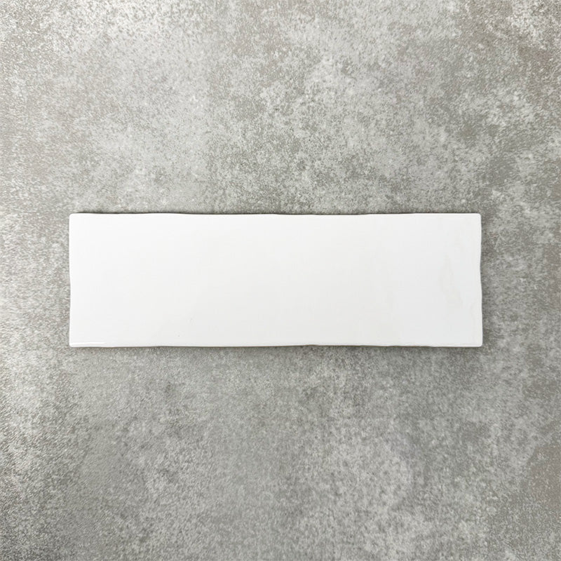 Close-up of Foundry Bricks Arctic White 6.5x20cm brick wall tile, showcasing clean white tones with a smooth, lightly textured surface and gently irregular edges, highlighting a refined, contemporary finish.