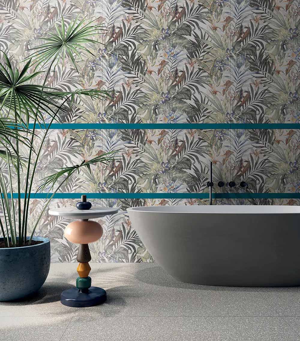 Bathroom featuring Bahamas 60 × 120cm wall and floor tiles, showcasing a layered tropical leaf design with soft neutral tones and subtle colour accents. Paired with a freestanding bath and statement details for a relaxed, design-led space.