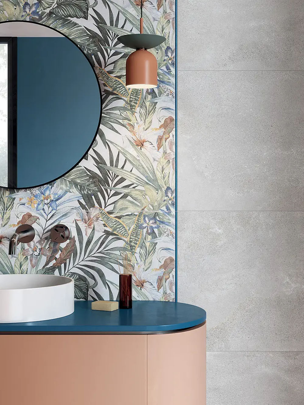 Bathroom featuring Bahamas 60 × 120cm wall tiles with a detailed tropical leaf design, used as a feature wall. Paired with soft concrete-effect tiles and a curved vanity for a balanced, contemporary finish.