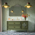 Bathroom featuring Balthazar Blue 20cm x 20cm Victorian Moroccan-style floor tiles, paired with Liberty Mint Green gloss wall tiles, a sage green vanity unit, brass fittings and decorative lighting.