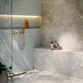 Bathroom featuring Baresi Cream 3D Terrazzo Effect 60x120cm porcelain tiles, showcasing a warm cream terrazzo effect design with subtle texture, paired with sage green feature wall tiles, brass fittings and a contemporary walk-in shower.