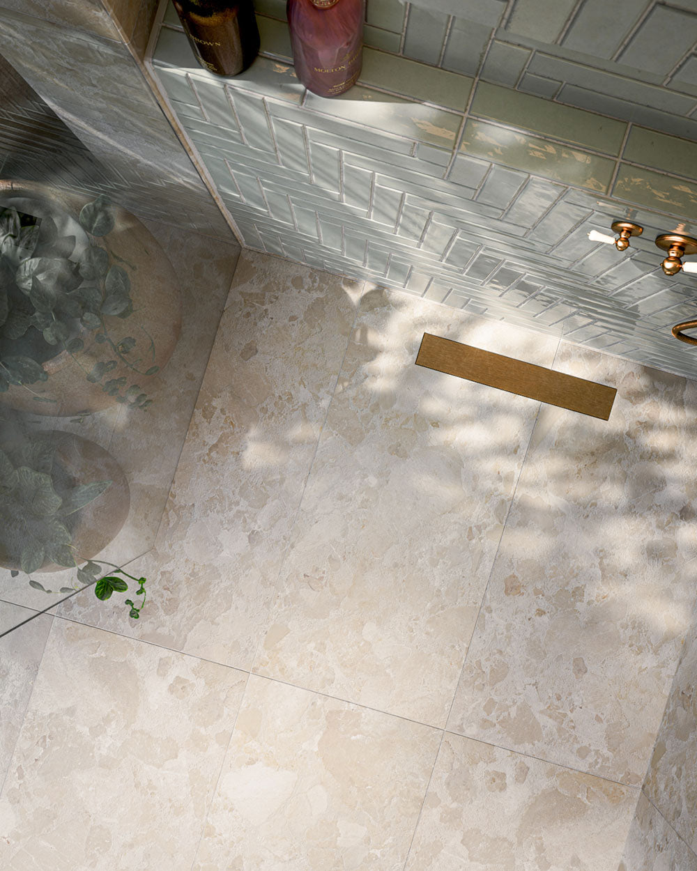 Bathroom featuring Baresi Cream 3D Terrazzo Effect 60x120cm porcelain tiles, showcasing a warm cream terrazzo effect design with subtle texture, paired with sage green feature wall tiles, brass fittings and a contemporary walk-in shower.