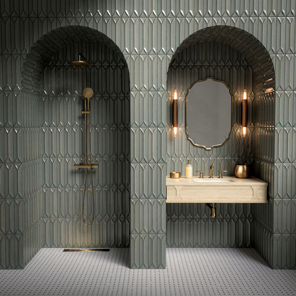 Bathroom vanity area featuring Baroque Decor Lichen Green 9.1x37.5cm porcelain wall tiles, showcasing a glossy fluted design in soft green tones, paired with a stone basin, brass fittings and warm ambient lighting.