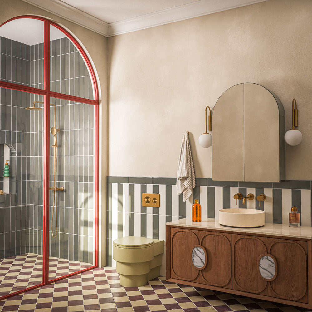 Contemporary bathroom featuring Baroque Vanilla porcelain wall tiles in a vertical stacked layout, paired with a burgundy and white chequerboard floor, walnut vanity, brushed brass fittings, an olive green WC and a striking red-framed shower enclosure for a bold, retro-inspired interior.