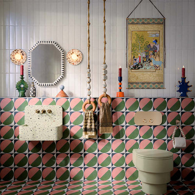 Bathroom featuring Baroque Vanilla 9.1x37.5cm porcelain wall tiles, paired with bold geometric patterned wall and floor tiles, terrazzo-effect basin, and eclectic décor for a playful contemporary interior.