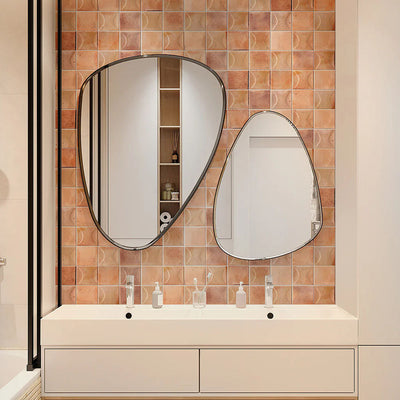 Bathroom wall featuring Saigon Rose Pink Decor Square Wall tiles in a Moroccan-inspired style, 10 × 10cm glossy ceramic tiles in soft blush and rose tones with a decorative relief pattern, paired with sculptural mirrors and a minimalist vanity.