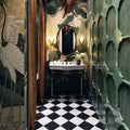 Bathroom setting featuring Manor Plain White Base 20x20cm tiles paired with contrasting black tiles in a classic chequerboard layout, creating a bold geometric floor, styled with rich wall tones and brass accents for a striking, timeless finish.