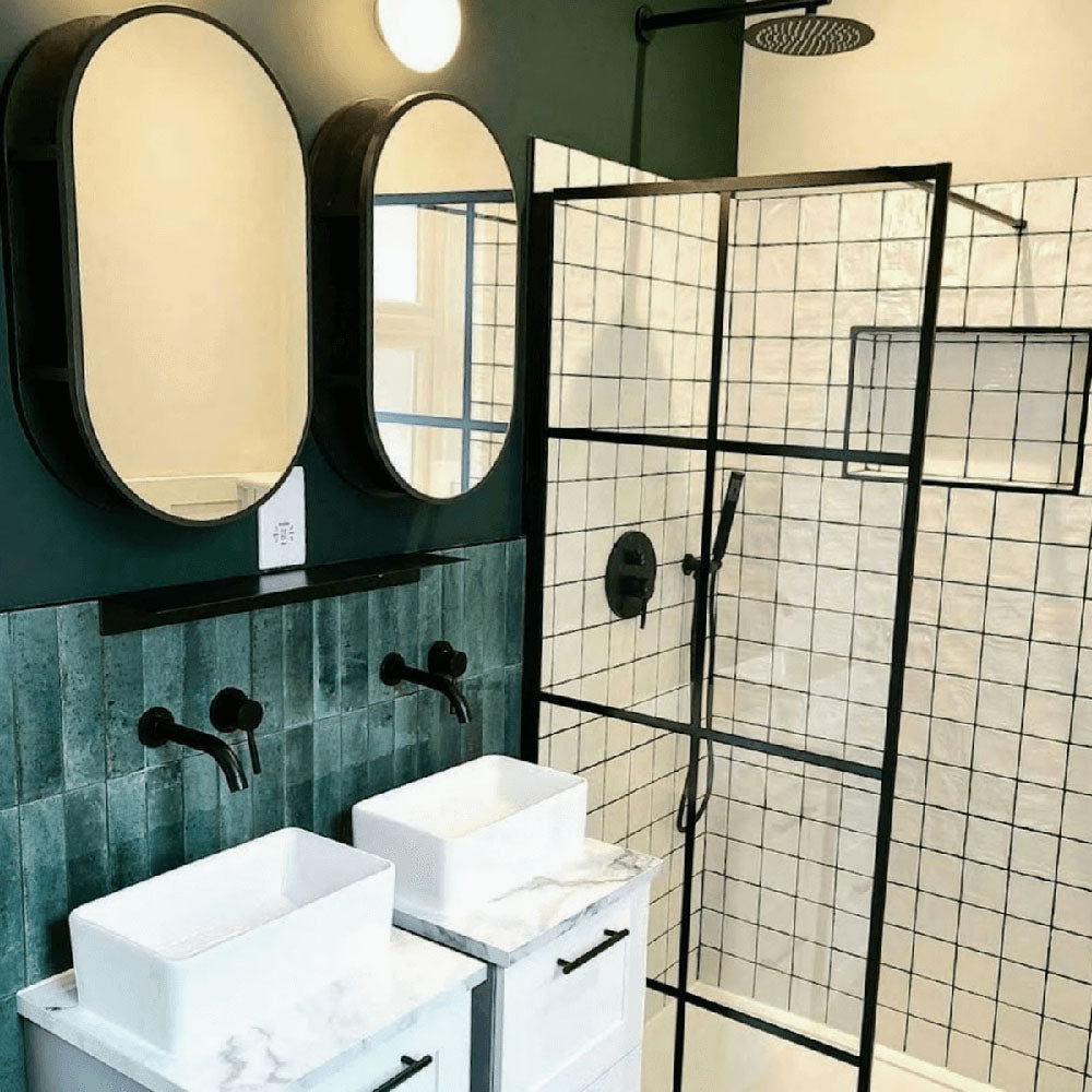 Bathroom featuring Zellige Oyster Square Moroccan-style ceramic tiles in a 10 × 10cm format, installed in a clean grid layout across the shower walls, with a glossy oyster-white glaze, softly uneven surfaces and subtle tonal variation adding handcrafted texture alongside black-framed shower screens and contemporary fixtures.