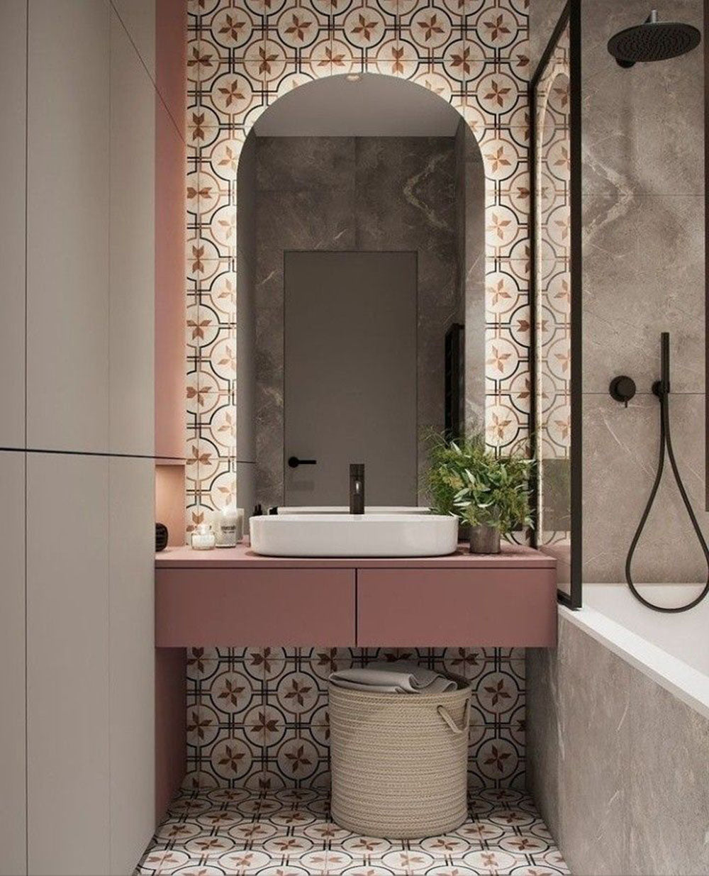 Bathroom setting featuring Viscount Rose 20x20cm Victorian style wall and floor tiles, showcasing a decorative geometric pattern in soft rose and neutral tones, paired with a blush vanity, marble surfaces and matte black fittings for a refined, contemporary take on a timeless design.
