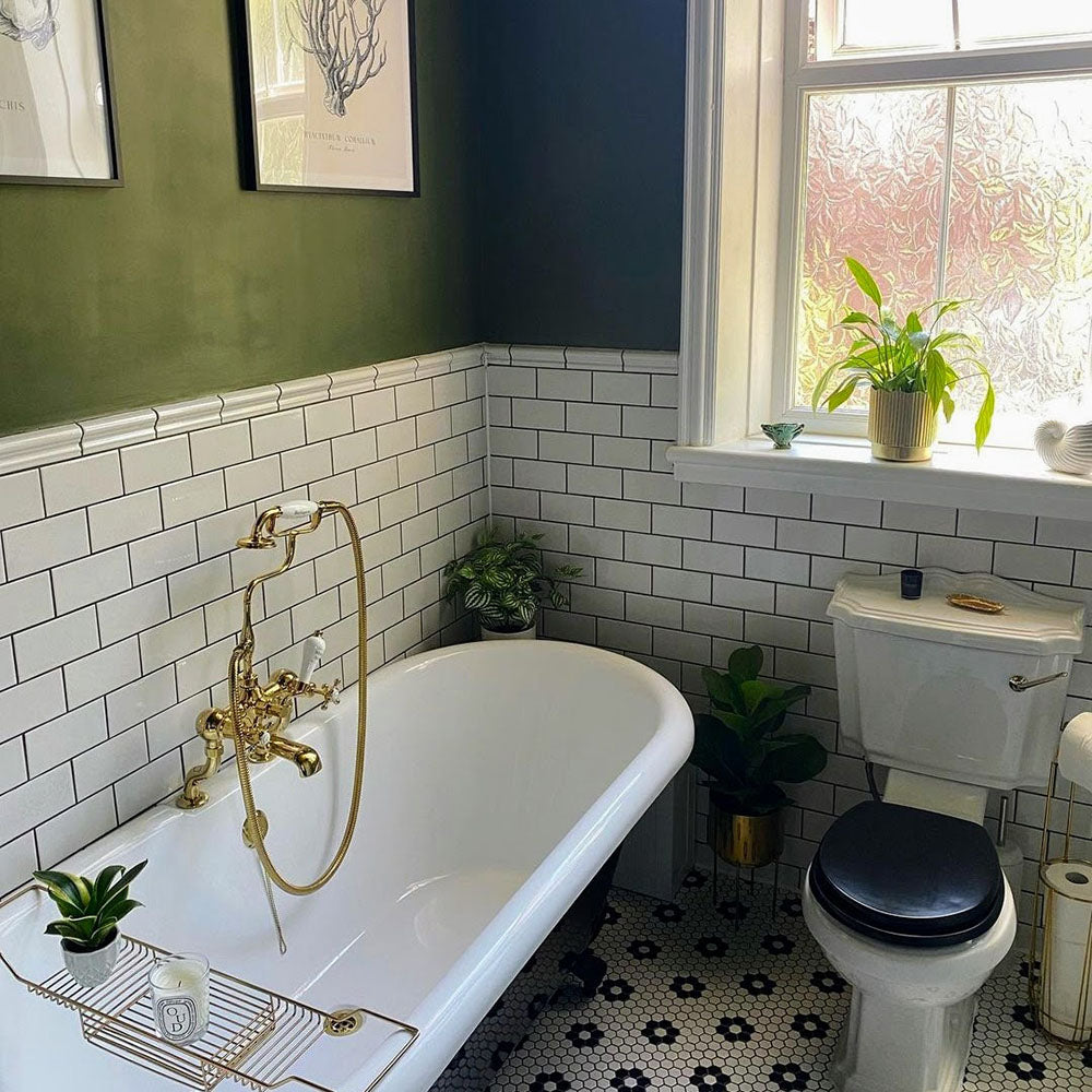 Bathroom featuring Pimlico White 7.5 × 15cm ceramic wall tiles with a crackle glaze finish, laid in a classic brick pattern and paired with a dark vanity, brass fittings and green walls.
