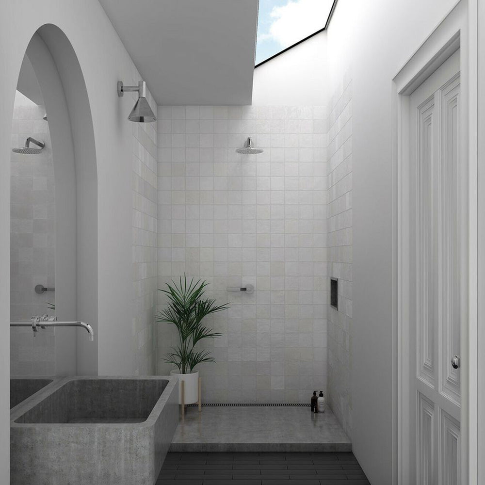 Minimalist shower area featuring Zellige White square tiles with a soft glossy finish, laid in a uniform grid for a clean, contemporary look.