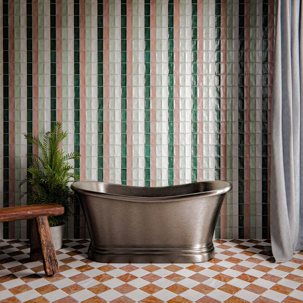 Bathroom interior featuring Fayrouz Rosso 15.2x15.2cm natural marble tiles with a tumbled finish, installed in a chequerboard floor with light marble, styled with a freestanding metal bathtub and vertically stacked green wall tiles.