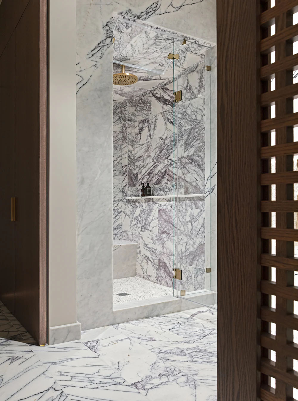 Bathroom interior featuring Fayrouz Lilac 30.5x61cm natural marble tiles with a honed finish, installed across the floor and shower walls to showcase a white base with striking lilac and grey veining, creating a cohesive, luxurious space with bold natural movement and variation.