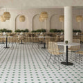 Restaurant interior featuring Belvoir Green 33 × 33cm Victorian style porcelain floor tiles, creating a classic geometric pattern with soft green and white tones. Paired with natural textures and warm lighting for an inviting, timeless setting.
