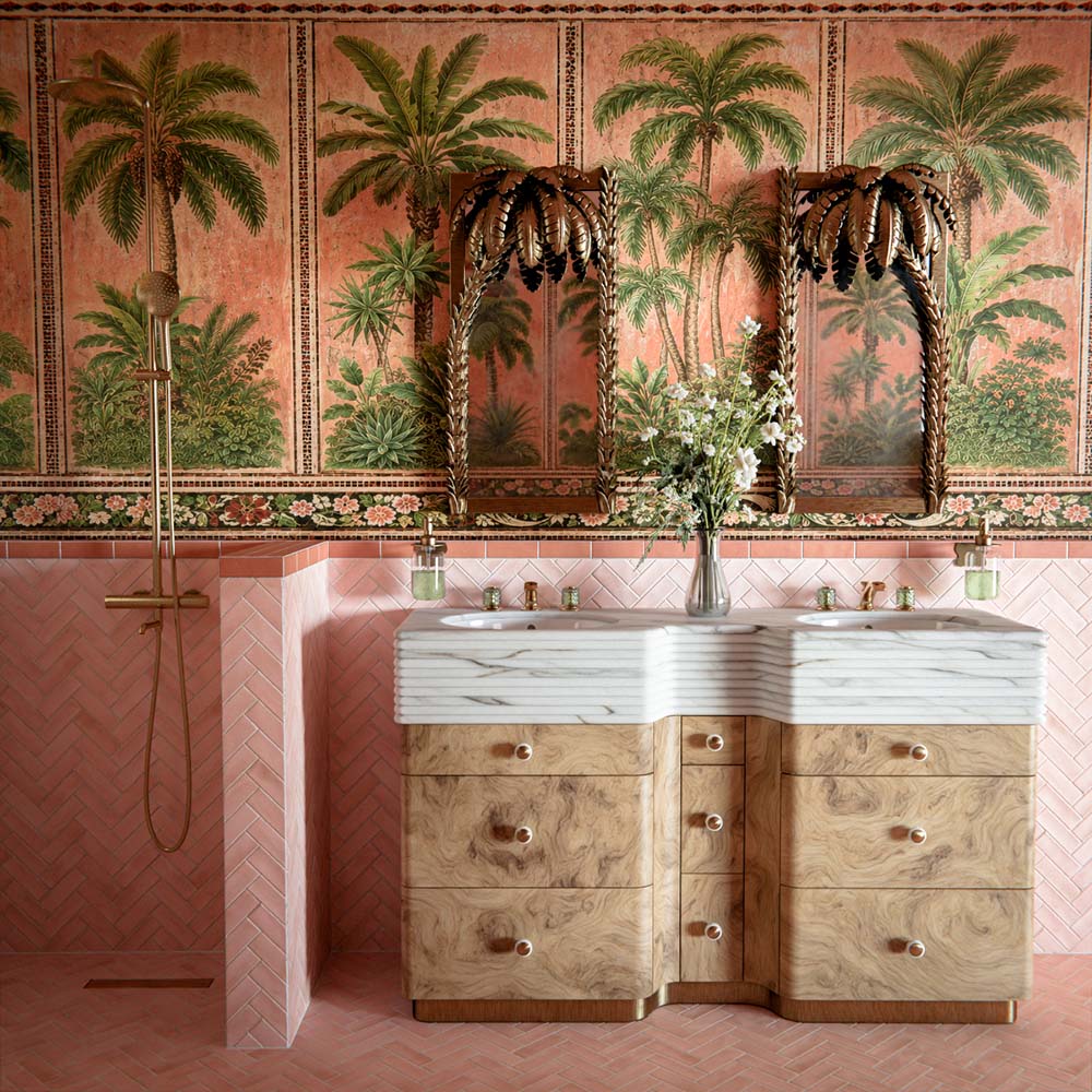 Bathroom featuring Benomar Pink Moroccan Mini Brick Matt 5x15cm wall tiles in a herringbone layout, styled with tropical palm wallpaper, carved wood mirrors, and marble-effect basins for a luxurious eclectic interior.