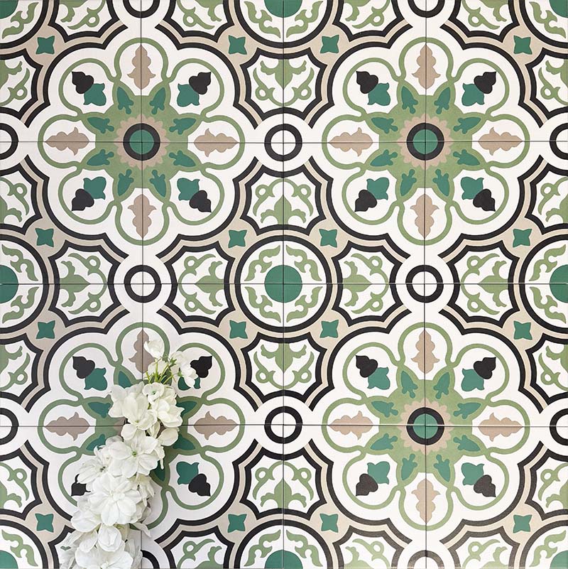 Group of London Streets Bond Street 20x20cm Victorian Moroccan style porcelain tiles arranged to showcase the repeating geometric pattern in green, black and cream tones, styled with white flowers in a decorative flat-lay setting.