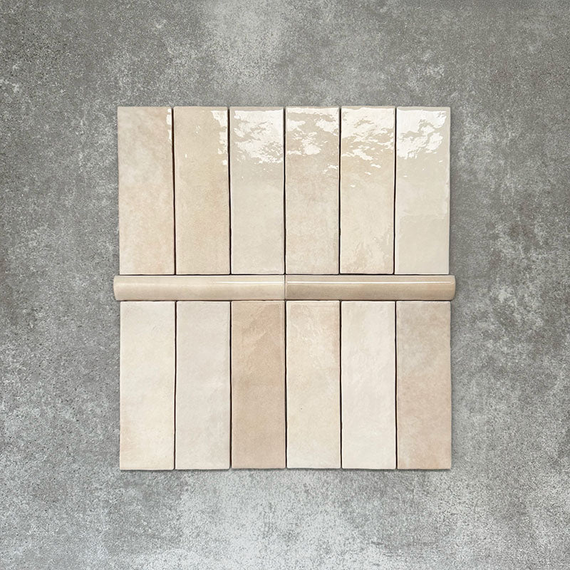 Zellige Bone bullnose ceramic tiles in a soft beige tone, paired with matching brick tiles in a flat lay layout.