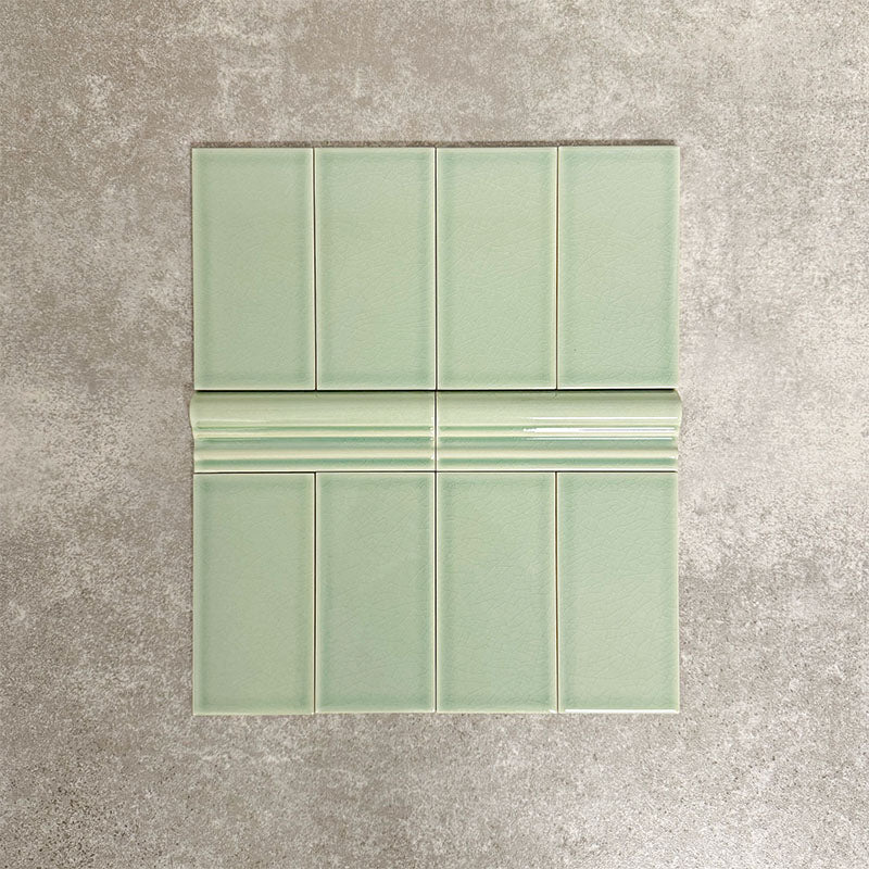 Pimlico Lime Green 7.5 × 15cm ceramic wall tiles with a crackle glaze finish, combined with matching 5 × 15cm dado trim to create a decorative horizontal feature, adding depth and classic detail to wall designs.