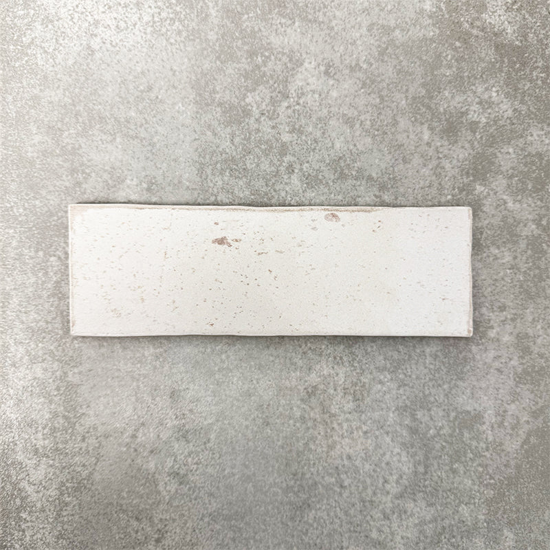 Close-up of Foundry Bricks Chalk White 6.5x20cm brick wall tile, showcasing soft off-white tones with subtle tonal variation, lightly textured surface and gently irregular edges for a refined, contemporary finish.