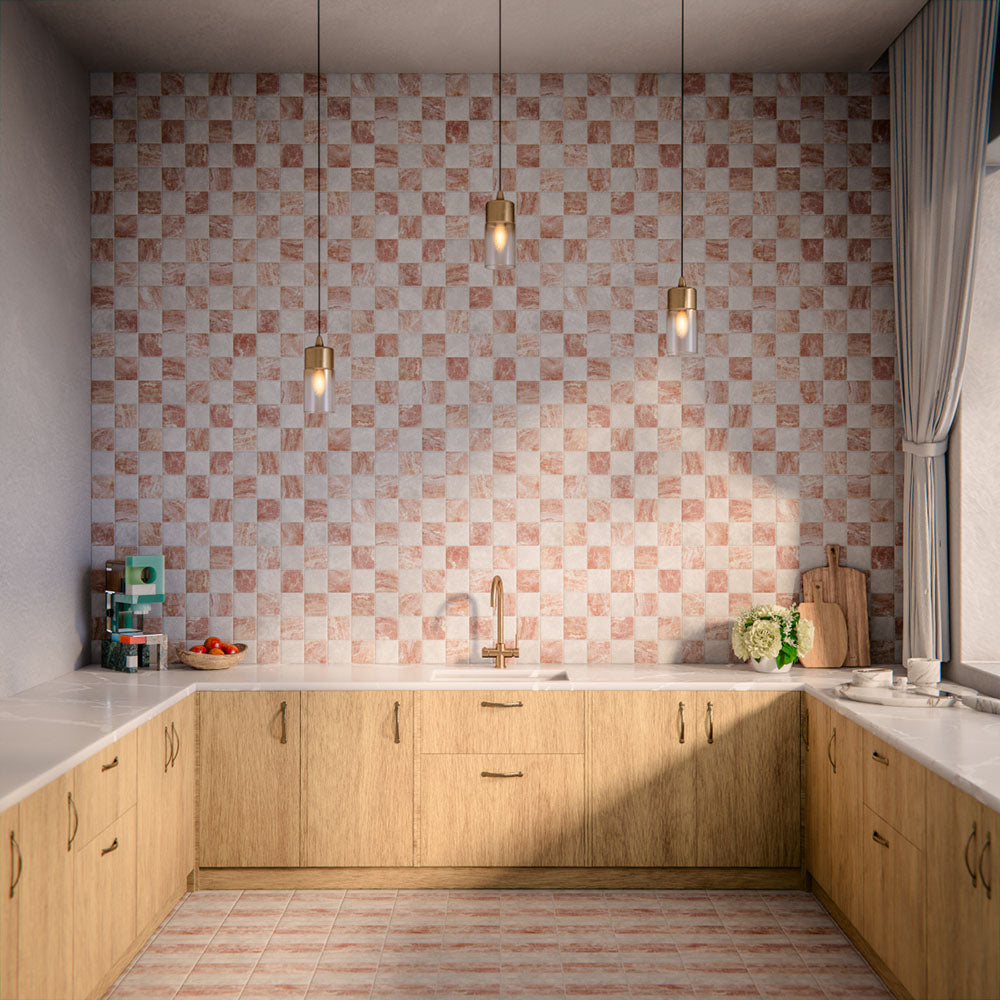 Kitchen interior featuring Amalfi patterned tiles in soft blush and ivory tones, installed as a chequerboard-effect splashback, styled with warm wood cabinetry, brass tap, pendant lighting, and natural accessories for a relaxed, contemporary space.