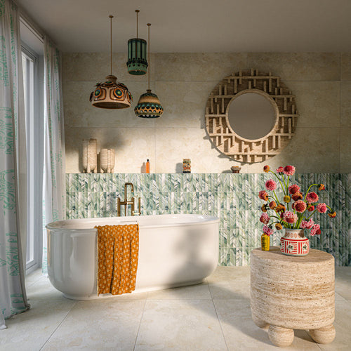 Bathroom featuring Crete Fluted Jade Matt 11.5x23cm green fluted wall tiles, styled with warm beige stone-effect porcelain tiles, a freestanding bath, brass fixtures, and bohemian-inspired décor.