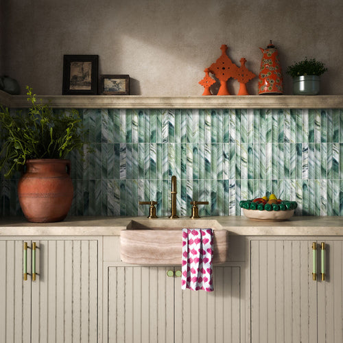Kitchen featuring Crete Fluted Jade Matt 11.5x23cm green marble-effect wall tiles with fluted detailing, styled with rustic cabinetry, brass fixtures, natural stone worktops, and Mediterranean-inspired décor.