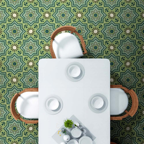 Dining area featuring Balthazar Verde 20×20cm Moroccan-style porcelain floor tiles, showcasing a detailed geometric pattern in layered green tones, styled with a white dining table and natural wood chairs to create a fresh, characterful interior.